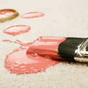Pink paint on paintbrush spilled on carpet